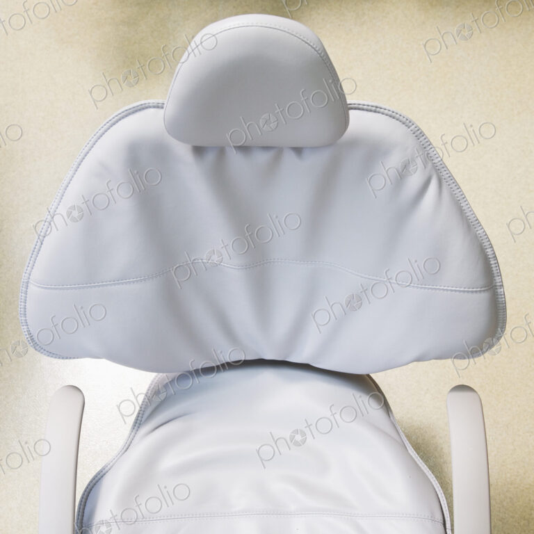 High angle view of white leather medical chair.