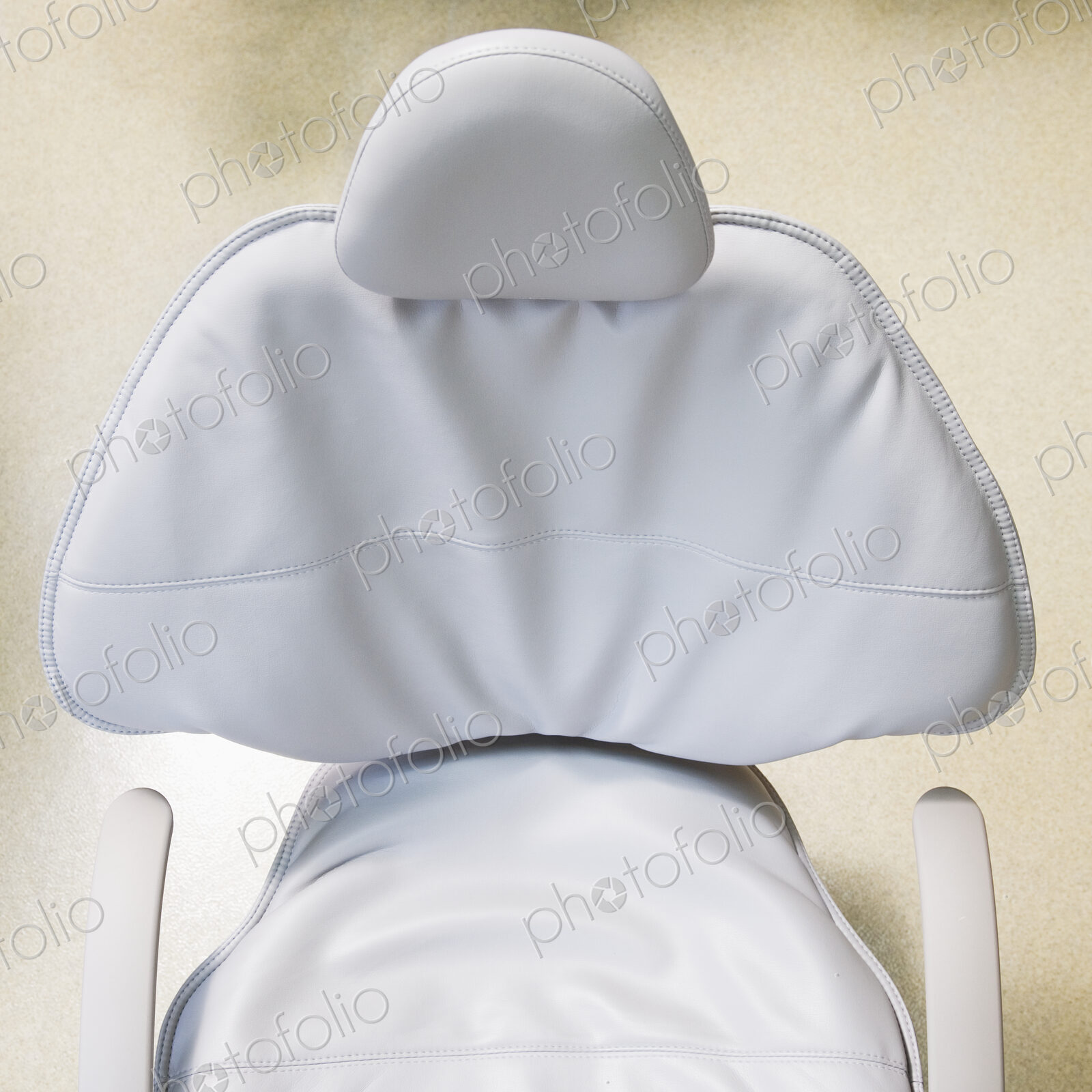 High angle view of white leather medical chair.