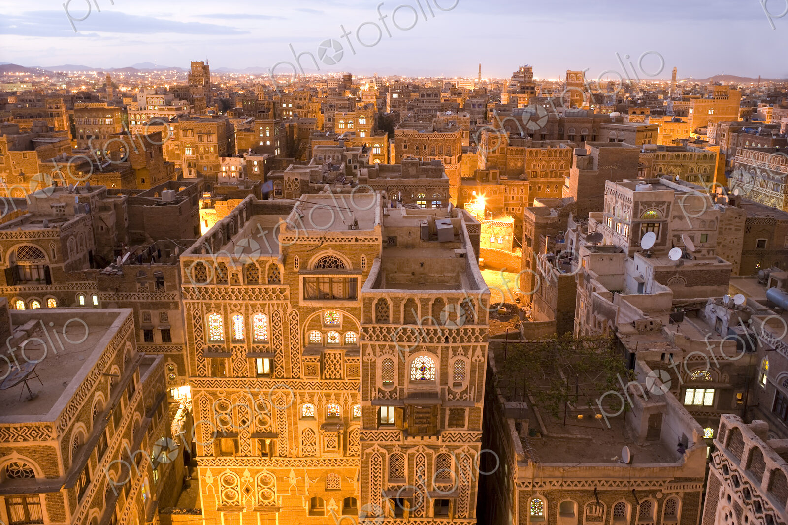 High angle view over rooftops of buildings in the old city of Sana’a in Yemen. A…