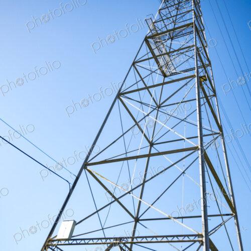 High transmission tower, a metal structure, low angle view of the structure. High transmission tower, a metal structure, low angle view of the structure.