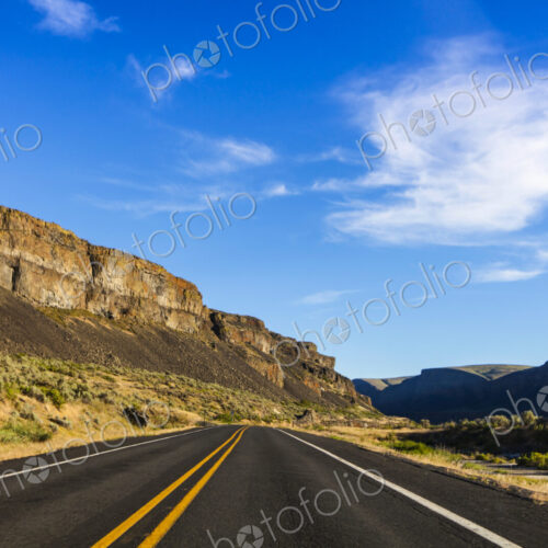 Highway 2, Coulee City, a highway under basalt cliffs in a canyon. Highway 2, Coulee City, a highway under basalt cliffs in a canyon.