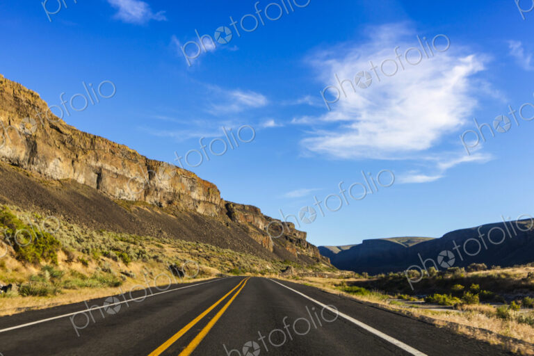 Highway 2, Coulee City, a highway under basalt cliffs in a canyon.