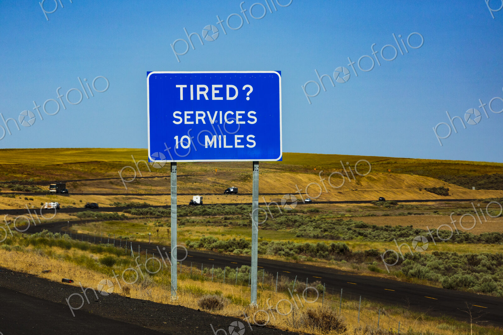Highway rest area sign, Interstate 90 at Sprague, message reading Tired? Services 10…