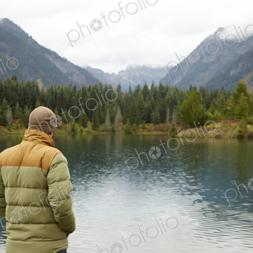 Hiker admiring lake and remote landscape