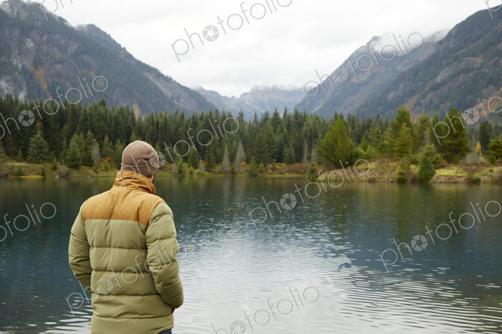 Hiker admiring lake and remote landscape