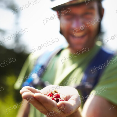 Hiker on Trail with Native Raspberries