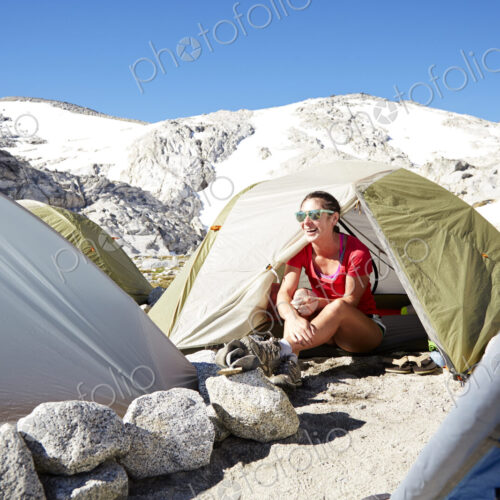 Hiker sitting in tent at campsite