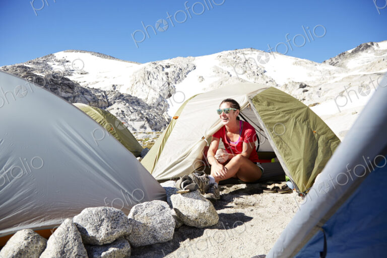 Hiker sitting in tent at campsite