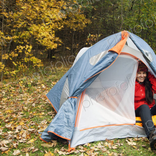 Hiker sitting in tent at campsite Hiker sitting in tent at campsite
