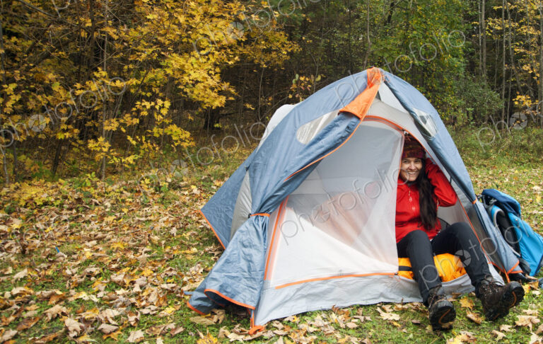 Hiker sitting in tent at campsite