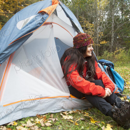 Hiker sitting in tent at campsite