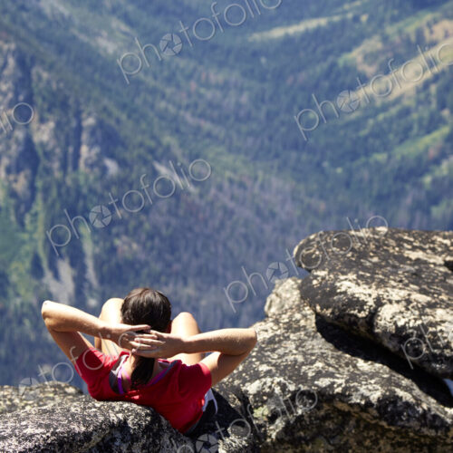 Hiker sitting on rocky hilltop Hiker sitting on rocky hilltop