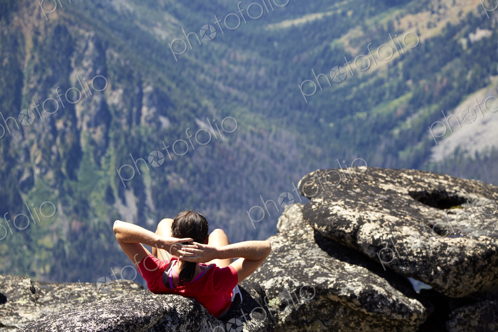 Hiker sitting on rocky hilltop