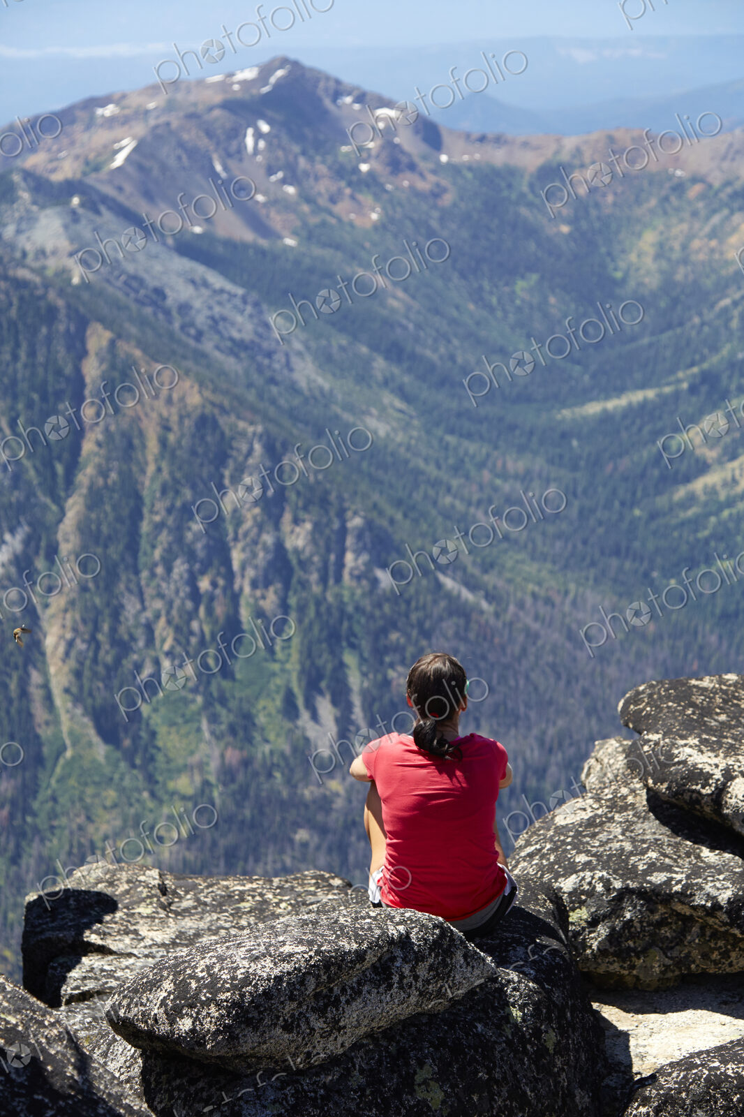 Hiker sitting on rocky hilltop