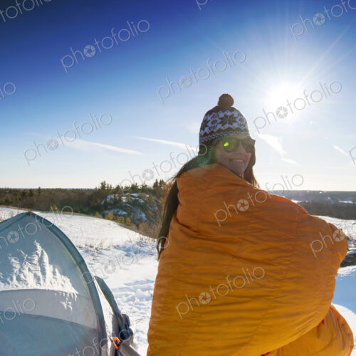Hiker standing at snowy campsite