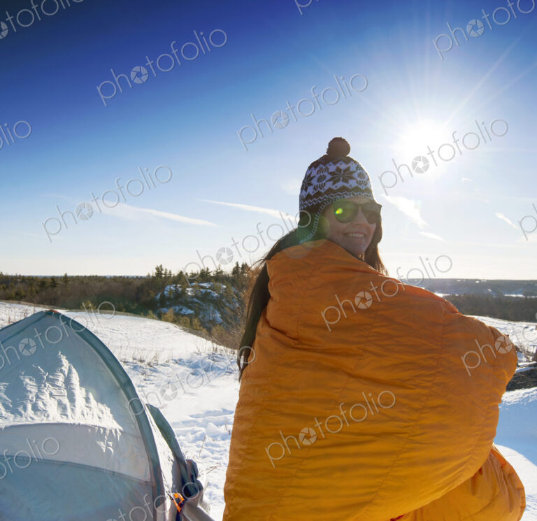 Hiker standing at snowy campsite