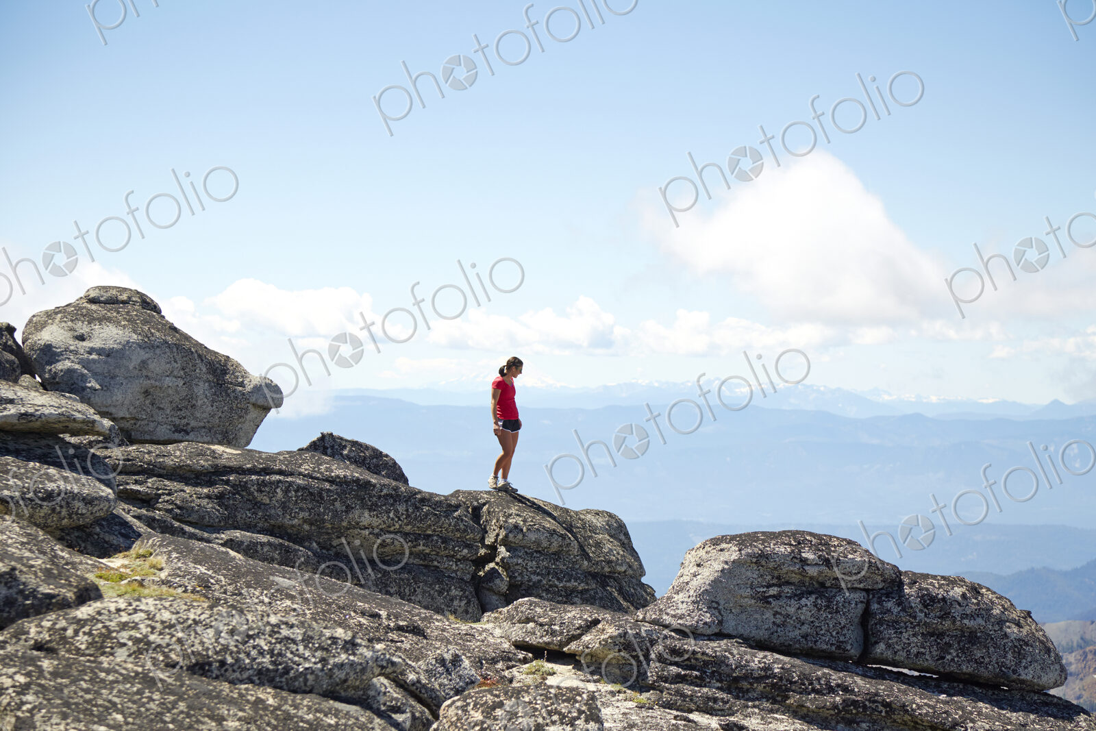 Hiker standing on hilltop in remote landscape