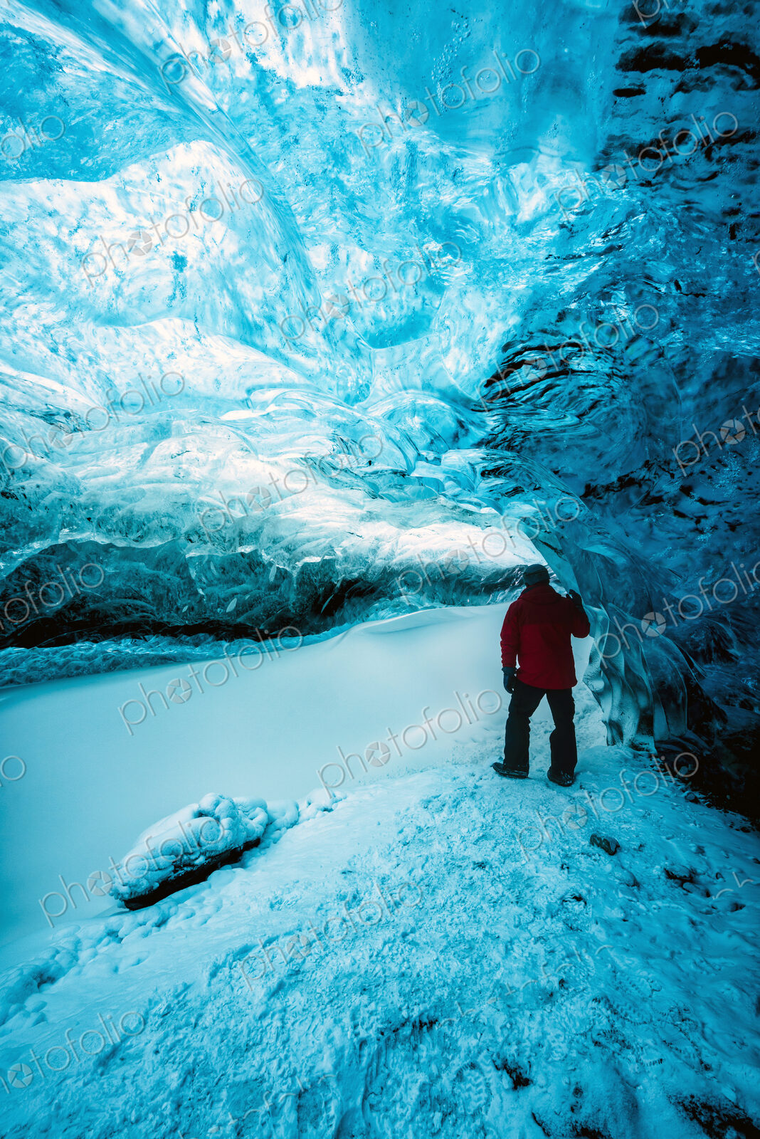 Hiker walking in ice cave