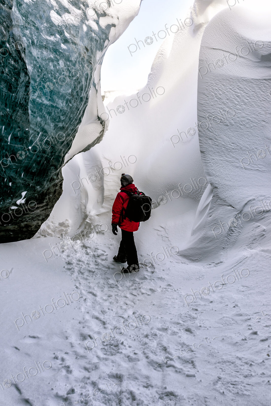 Hiker walking in snowy ice cave