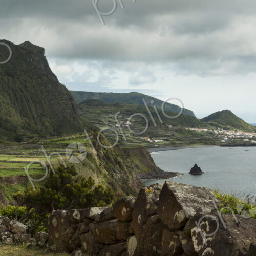 Hiker walking on coastal path in rural landscape Hiker walking on coastal path in rural landscape