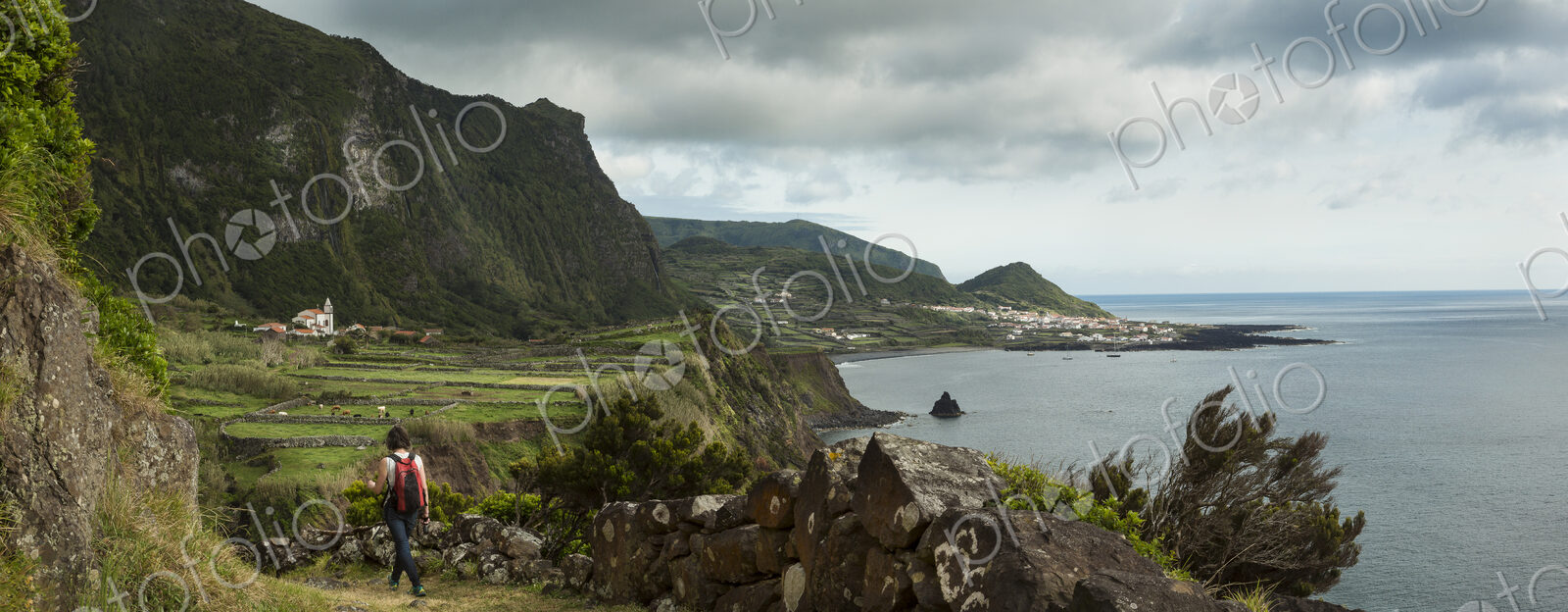 Hiker walking on coastal path in rural landscape
