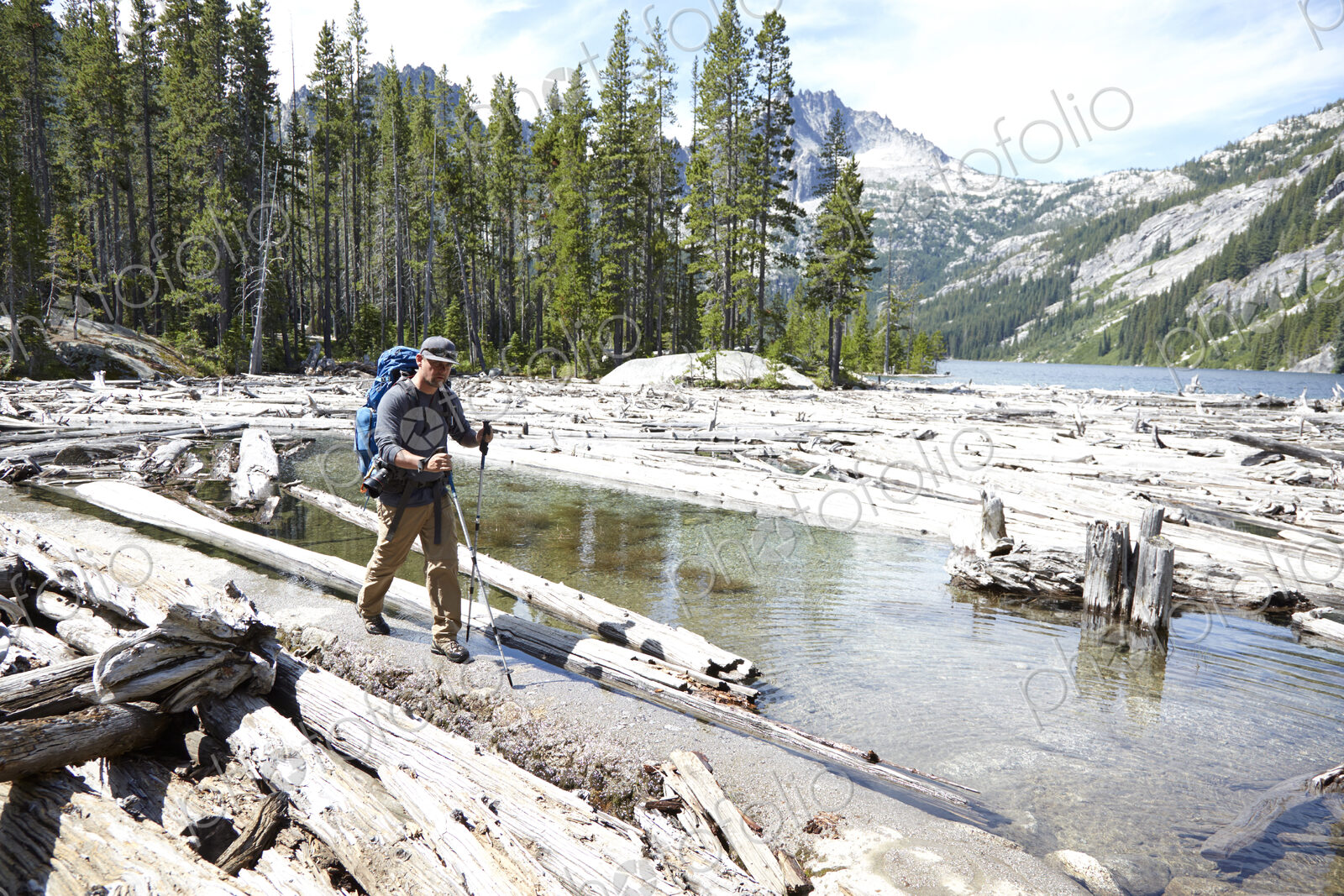Hiker walking on dirt path by remote lake
