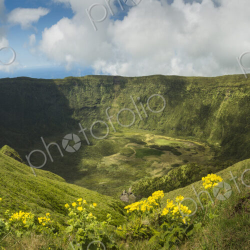 Hiker walking on hilltop dirt path over Cabeco Gordo crater, Faial, Portugal Hiker walking on hilltop dirt path over Cabeco Gordo crater, Faial, Portugal
