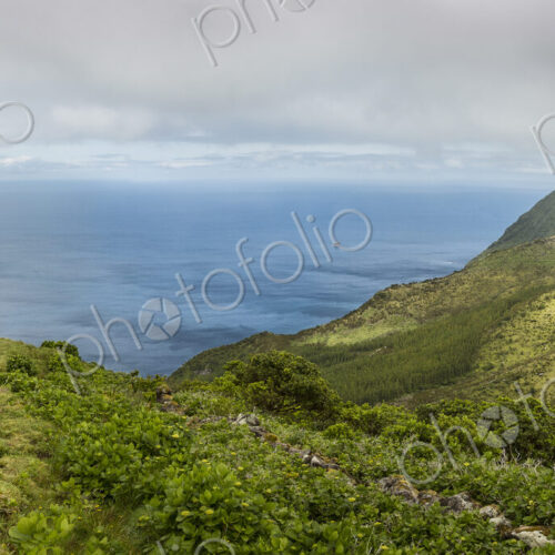 Hiker walking on hilltop path in rural landscape Hiker walking on hilltop path in rural landscape