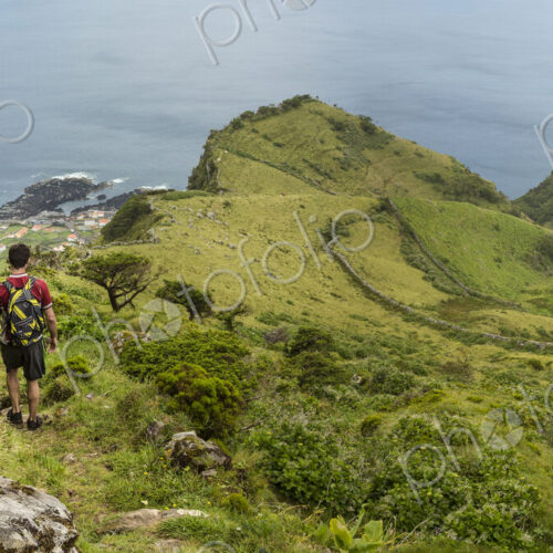 Hiker walking on hilltop path in rural landscape Hiker walking on hilltop path in rural landscape