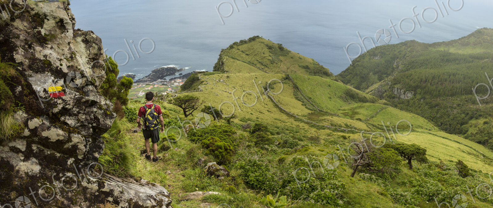Hiker walking on hilltop path in rural landscape