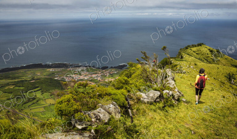 Hiker walking on hilltop path in rural landscape