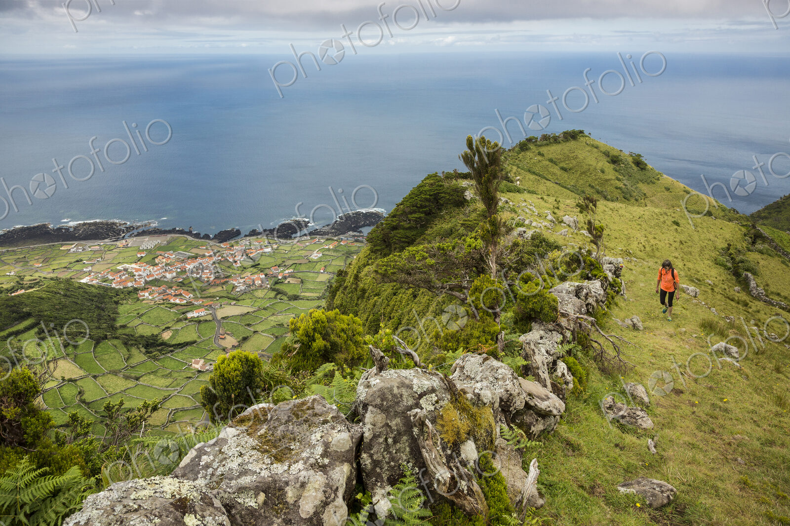 Hiker walking on hilltop path in rural landscape