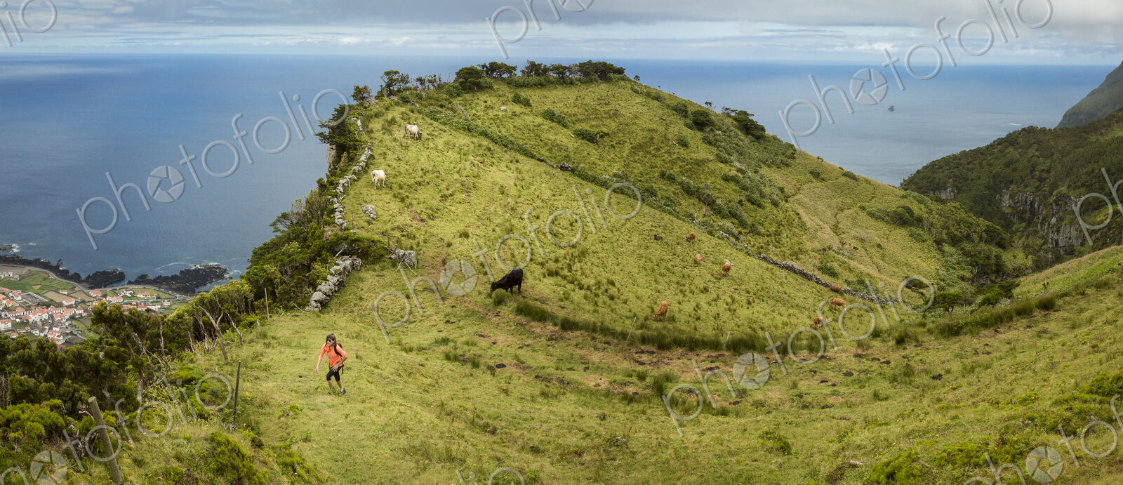 Hiker walking on hilltop path in rural landscape