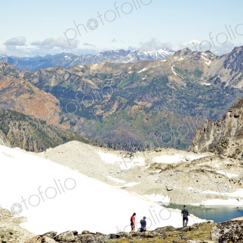 Hikers admiring mountains in remote landscape