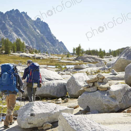 Hikers backpacking in rocky rural landscape Hikers backpacking in rocky rural landscape