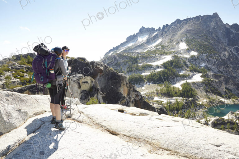 Hikers standing on rocky hilltop