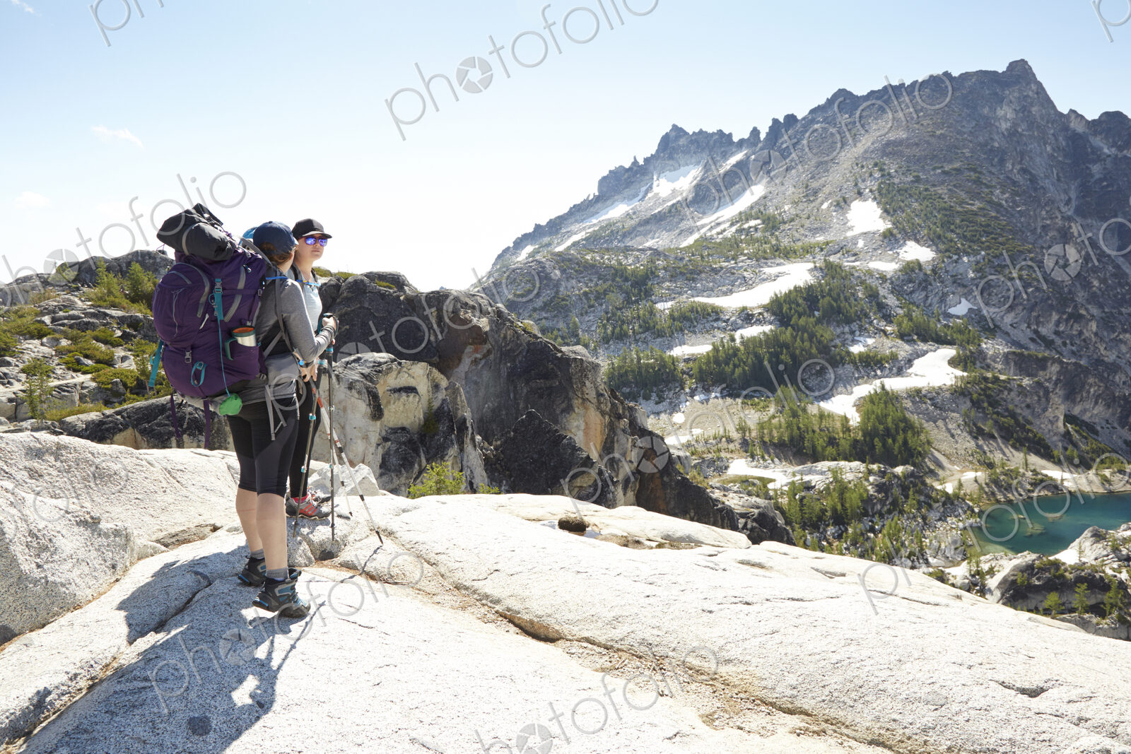 Hikers standing on rocky hilltop