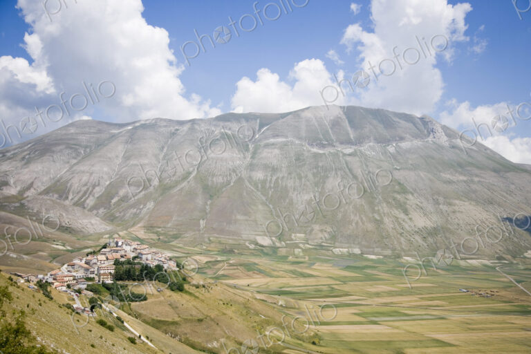 Hilltop Town With Mountain in Background