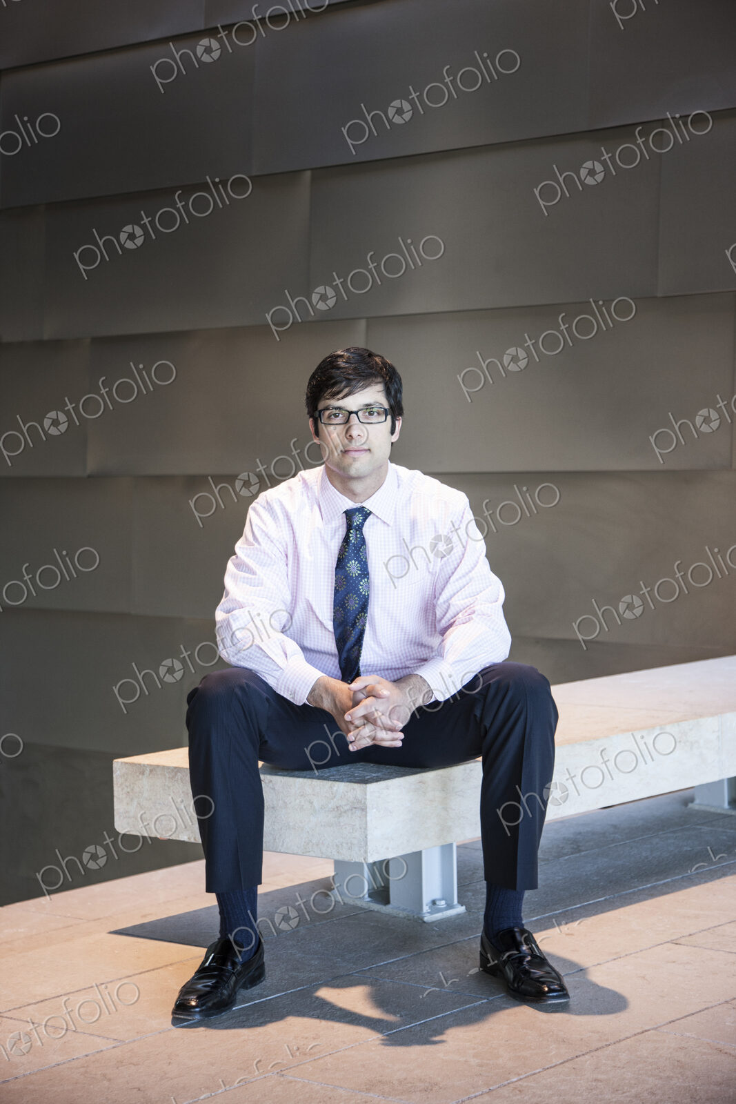 Hispanic business man in an office lobby.