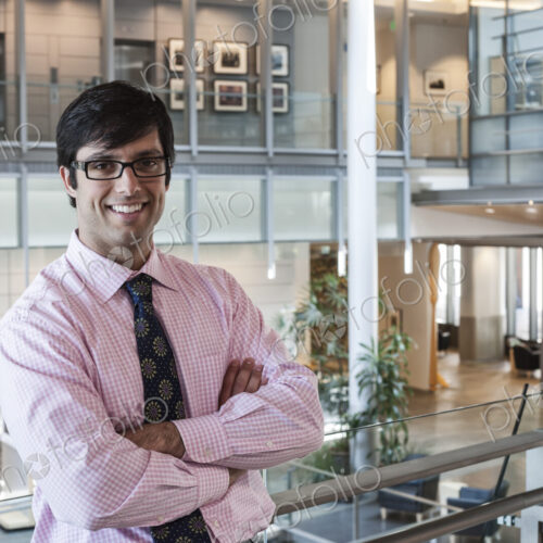 Hispanic business man in an office lobby. Hispanic business man in an office lobby.