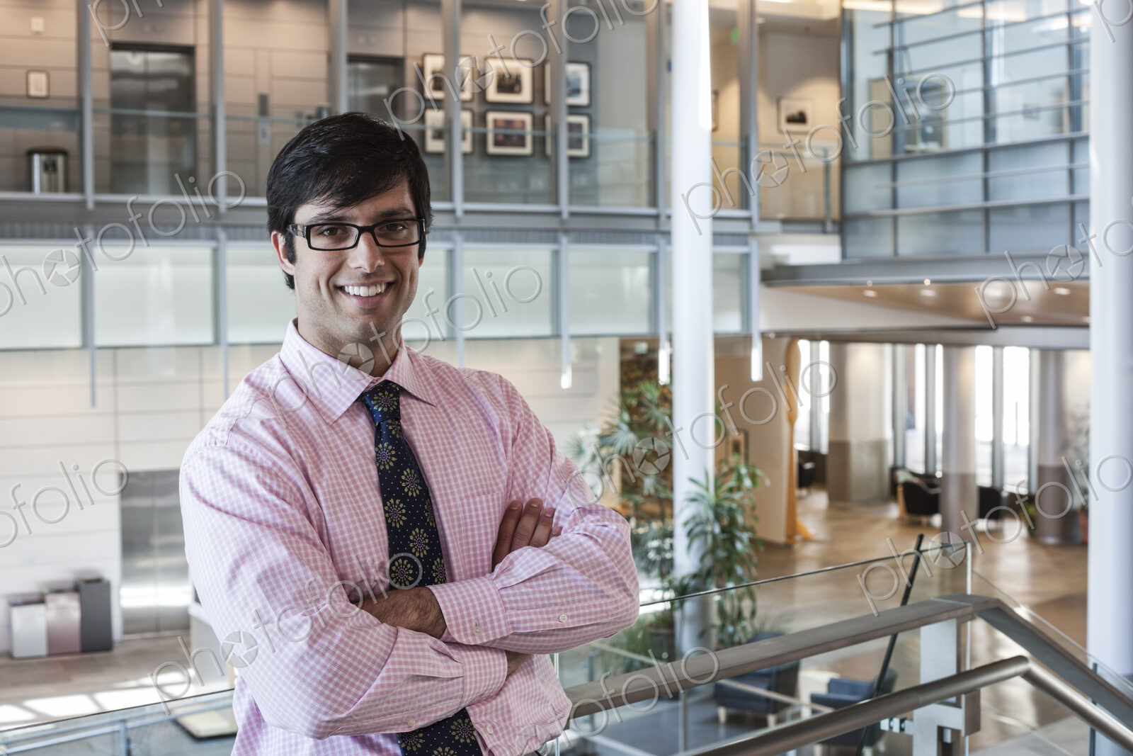 Hispanic business man in an office lobby.
