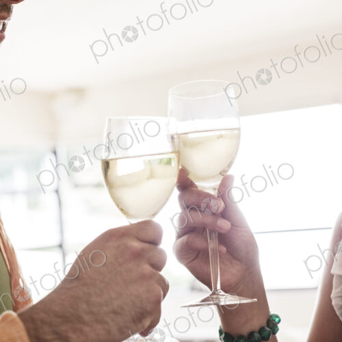 Hispanic couple having a glass of white wine together. Hispanic couple having a glass of white wine together.
