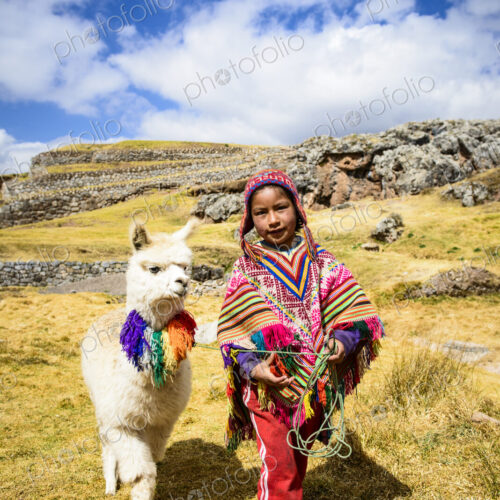 Hispanic girl walking llama in rural landscape Hispanic girl walking llama in rural landscape