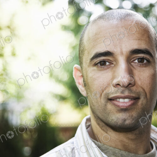 Hispanic man in the backyard of his home. Hispanic man in the backyard of his home.