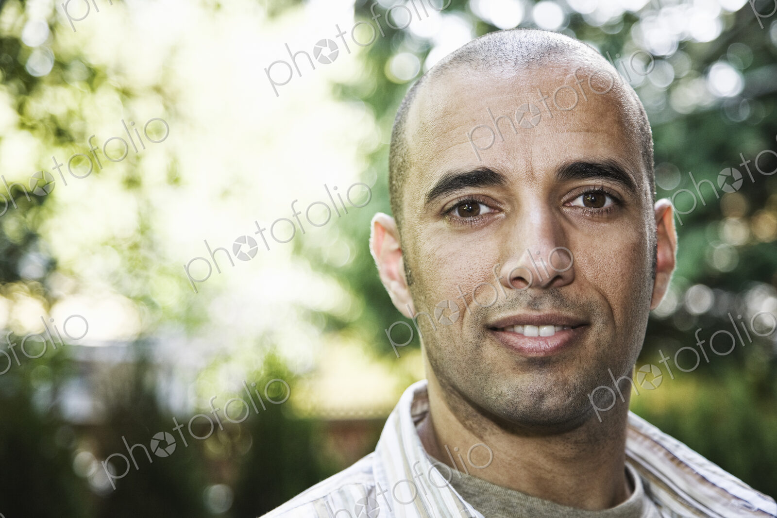 Hispanic man in the backyard of his home.
