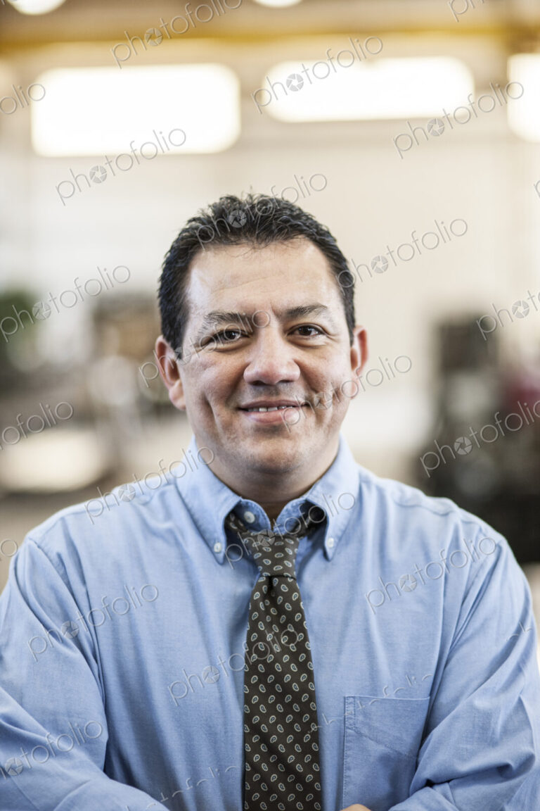 Hispanic man manager in a sheet metal factory.