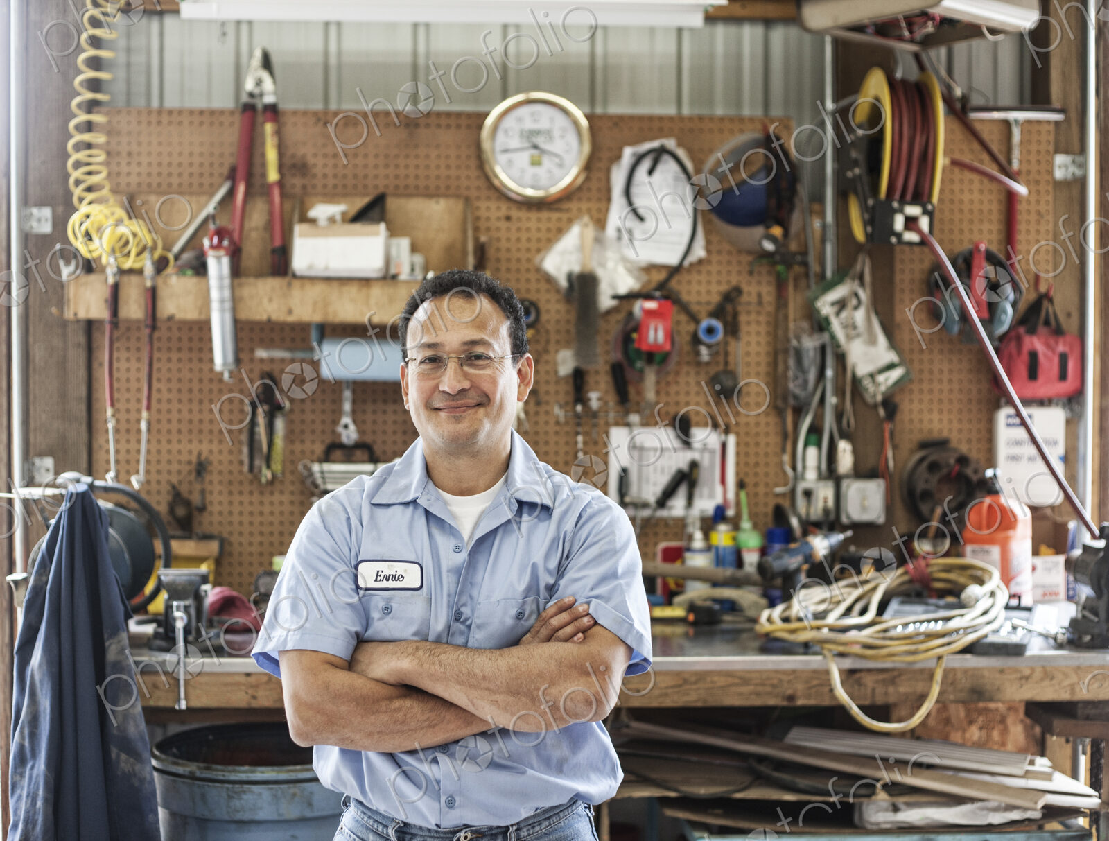 Hispanic man worker in the shop area of a landscape company.