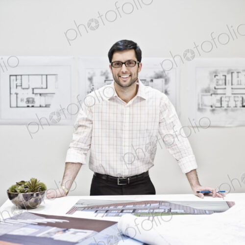Hispanic man working in an architect's office. Hispanic man working in an architect's office.