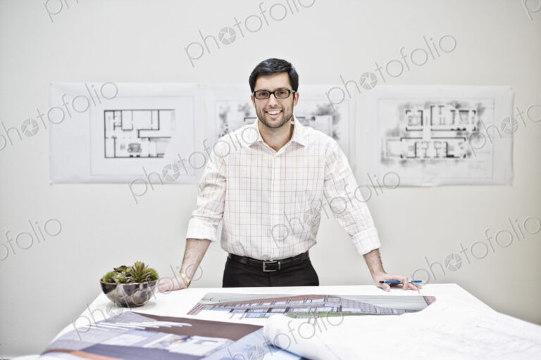 Hispanic man working in an architect's office.