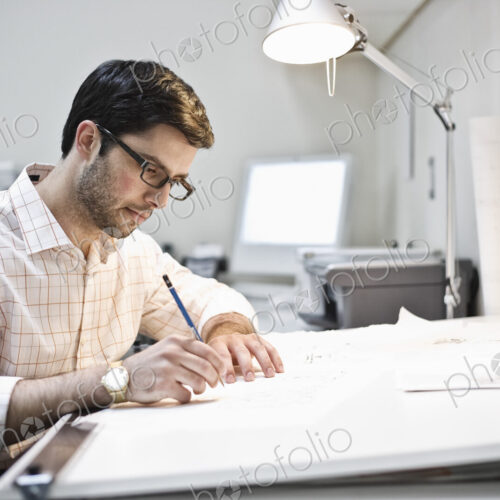 Hispanic man working in an architect's office. Hispanic man working in an architect's office.